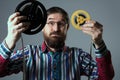 Bearded man with two film reel Royalty Free Stock Photo