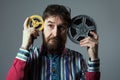 Bearded man with two film reel Royalty Free Stock Photo