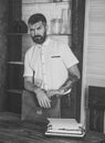 Bearded man with vintage briefcase and typewriter at desk