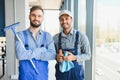 bearded man washing office windows near blurred multicultural women, banner