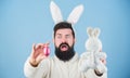 Bearded man wear bunny ears. Egg hunt. Look what i found. Hipster cute bunny blue background. Easter bunny. My precious