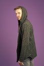 Bearded man wear hood on violet background. Man in casual sweatshirt. Fashion model in grey hoodie. Active lifestyle and