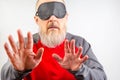 Bearded man wearing a blindfold for sleeping. Concept of a blind man searching in the dark