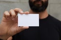 Bearded Man Wearing Casual Black Tshirt Showing Blank White Business Card.Blurred Background Ready Corporate Private