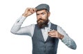 Bearded man wearing suit and drinking whiskey, brandy, cognac. Bearded in is holding a glass of whiskey. Sommelier