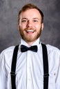Bearded man in white shirt and bow tie in front of gray backgro Royalty Free Stock Photo