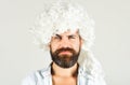 Bearded man in white wig. Smiling man with beard and mustache in curly wig. Bearded hipster in wig. Man in periwig