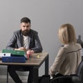 Bearded man and woman have business meeting. Businessman and businesswoman sit at office desk. Concentration at work Royalty Free Stock Photo