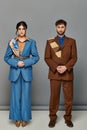 bearded man and woman, tailored suits