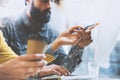 Bearded man and woman working together in modern office. Girl holding a pen in hand pointing to computer screen Royalty Free Stock Photo