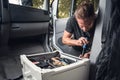 Man installing additional batteries in his camper van