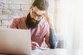 Man working with laptop and writing with pen Royalty Free Stock Photo