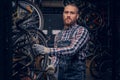 Mechanic doing bicycle wheel service manual in a workshop. Royalty Free Stock Photo