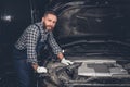 Bearded mechanical male in a garage.