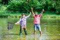 Bearded men catching fish. Master baiter. Mature man with friend fishing. Summer vacation. Happy cheerful people Royalty Free Stock Photo