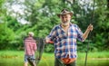 Bearded men catching fish. Mature man with friend fishing. Summer vacation. Happy cheerful people. Master baiter Royalty Free Stock Photo