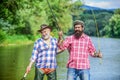 Bearded men catching fish. Mature man with friend fishing. Summer vacation. Happy cheerful people. Family time Royalty Free Stock Photo