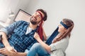 Father and little daughter at home sitting girl tighten tie on father`s head cheerful Royalty Free Stock Photo