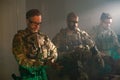 Bearded men in military equipment in dark room Royalty Free Stock Photo