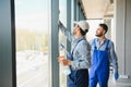 bearded man washing office windows near blurred multicultural women, banner