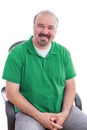 Bearded Middle Age Man Smiling on his Chair Royalty Free Stock Photo