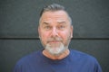 Bearded middle aged man staring at camera in consternation Royalty Free Stock Photo