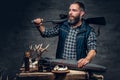 Bearded modernl hunter with his trophy holds a rifle. Royalty Free Stock Photo