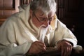 Bearded monk writing with quill Royalty Free Stock Photo