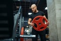 Bearded muscular man puts on weight on bar in gym Royalty Free Stock Photo