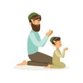 Bearded muslim man and his son praying to Allah. Islamic religion. Arab family. Father and child in national headdress Royalty Free Stock Photo