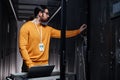 Bearded network engineer using laptop while working in server room Royalty Free Stock Photo