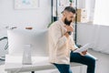 Bearded office worker watching at papers and thinking Royalty Free Stock Photo
