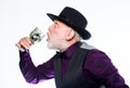 Bearded old guy hold wineglass with spider inside. Extreme lifestyle. Exotic food. Cocktail with real spiders. Alcohol Royalty Free Stock Photo