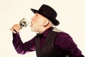 Bearded old guy hold wineglass with spider inside. Extreme lifestyle. Exotic food. Cocktail with real spiders. Alcohol Royalty Free Stock Photo