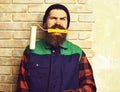 Bearded painter man holding roller paint with satisfied face Royalty Free Stock Photo