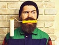 Bearded painter man holding roller paint with serious face Royalty Free Stock Photo