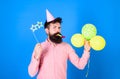Bearded party entertainer at kids celebration, International children day concept. Man with bright balloons, paper