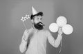 Bearded party entertainer at kids celebration, International children day concept. Man with bright balloons, paper