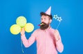 Bearded party entertainer at kids celebration, International children day concept. Man with bright balloons, paper