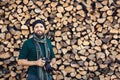 Bearded photographer with digital camera on firewood wall background Royalty Free Stock Photo