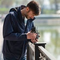 Bearded photographer photographs with enthusiasm the film camer