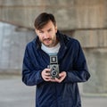 Bearded photographer photographs with enthusiasm the film camer