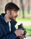 Bearded photographer photographs with enthusiasm the film camer