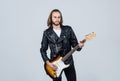 bearded rocker in leather jacket. man long hair play electric guitar. rock music style. Royalty Free Stock Photo