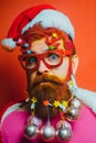 Bearded Santa Claus - close up portrait. Beard with Christmas decoration. Funny santa Wish you merry christmas.