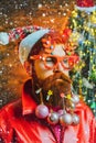 Bearded Santa Claus - close up portrait. Bearded crazy Santa looking at the camera. Christmas santa wishes merry