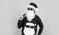 bearded santa man singing in microphone in hat smiling while prepare for celebrating happy new year party and christmas Royalty Free Stock Photo