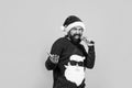 bearded santa man singing in microphone in hat smiling while prepare for celebrating happy new year party and christmas Royalty Free Stock Photo