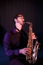 Bearded saxophonist in glaces. Saxophone on a foreground