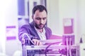 Bearded scientist feeling very busy and pressed for time working in laboratory